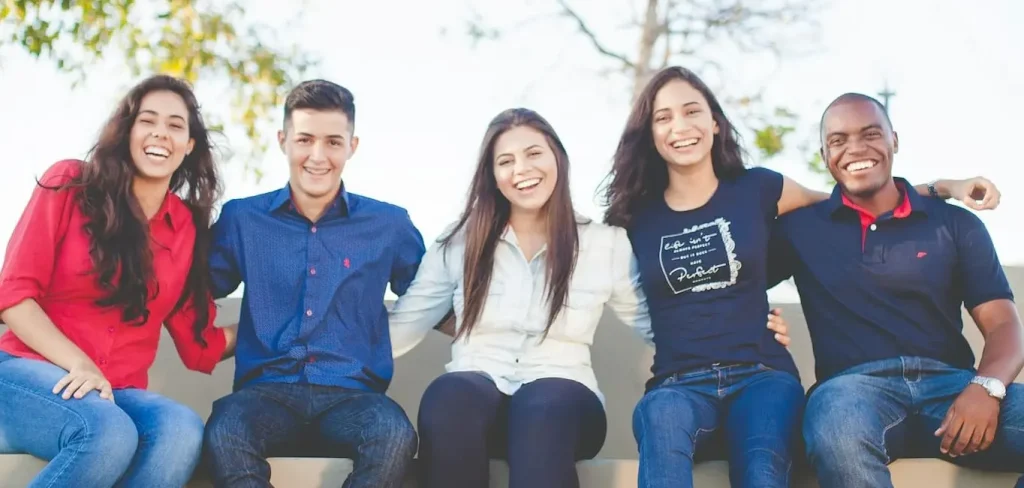 Diverse group of smiling young adults representing adult children of immigrants seeking identity and belonging.